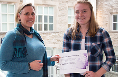 Sarah Gallagher presenting Summer Research Award to student